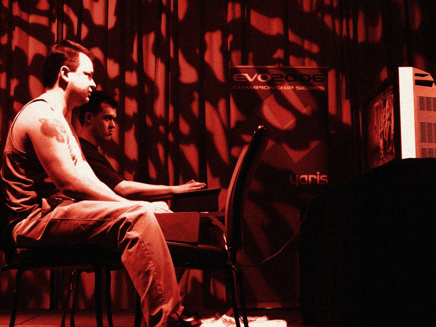 Two players seated side by side at the stage machine